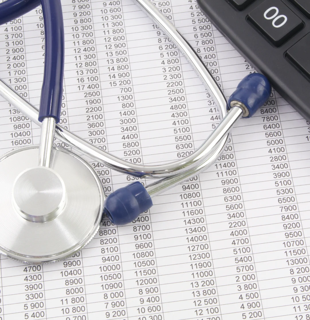 A stethoscope and calculator on top of a table.